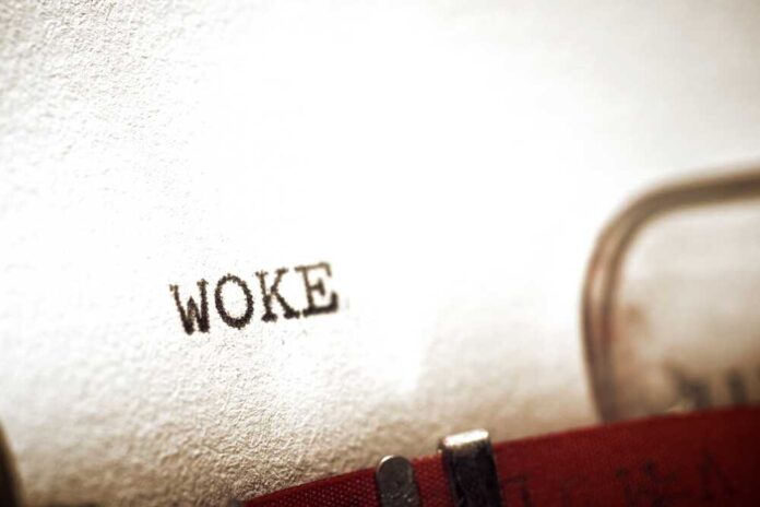 Close-up of the word WOKE typed on paper from a typewriter