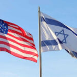 American and Israeli flags waving against a clear sky.
