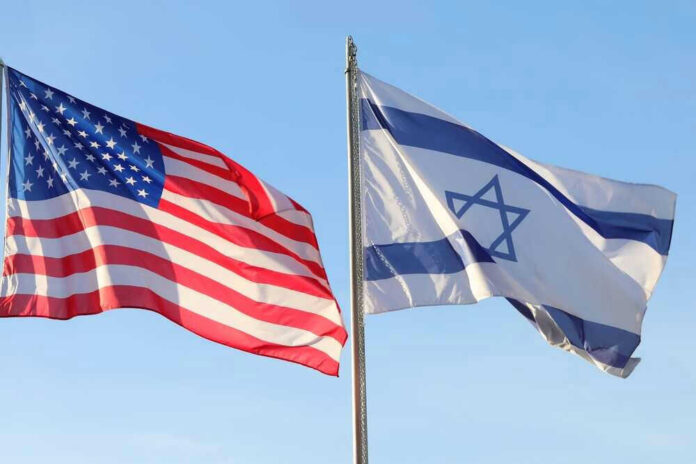 American and Israeli flags waving against a clear sky.