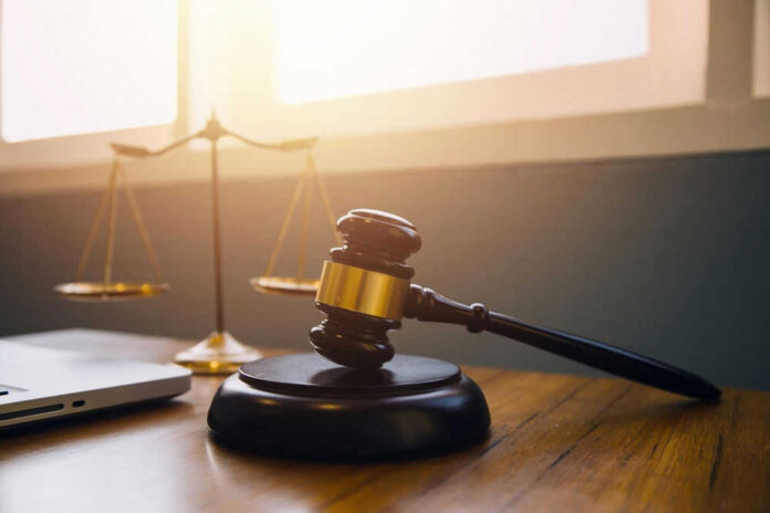 Gavel and scales of justice on desk.