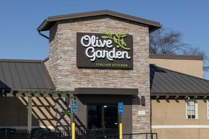 Exterior view of an Olive Garden restaurant with a stone facade