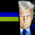 Ukraine flag on smartphone with President Donald Trump behind it