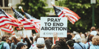 People holding a Pray to End Abortion sign.