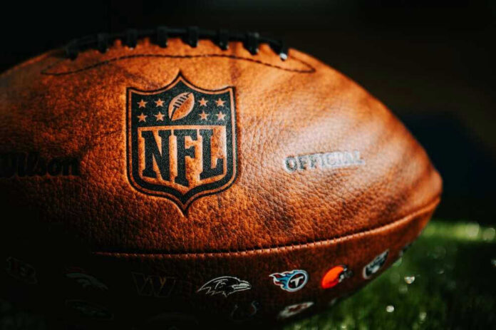 Close-up of an NFL football on grass.