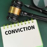 Landmark Conviction: Liberal Judge Out! A gavel resting on a notepad with the word 'CONVICTION' written on it