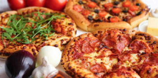 Three pizzas with various toppings and fresh ingredients.