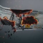 A hundred dollar bill appearing to burn and disintegrate