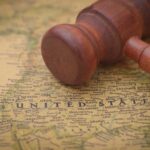 A wooden gavel resting on a map of the United States