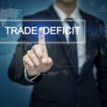 MASSIVE Trade Deficit Rocks U.S. Economy Businessman interacting with a digital display showing 'TRADE DEFICIT'