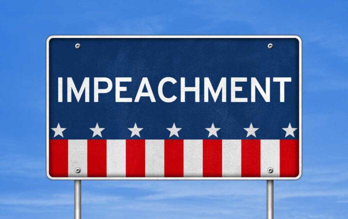 Sign displaying the word 'IMPEACHMENT' with a patriotic design