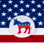 Democrat Power Broker Stepping Down Democratic Party donkey logo on American flag background.
