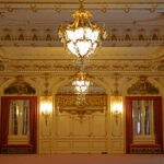 Trump’s Ballroom Will KILL Capitol Tradition Forever? Ornate interior of a luxurious room with chandeliers and decorative walls