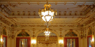 Ornate interior of a luxurious room with chandeliers and decorative walls