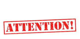 Red attention stamp on white background