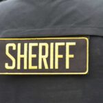 Close-up of a sheriff's uniform with a badge