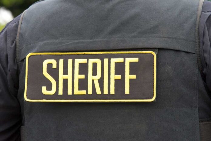 Close-up of a sheriff's uniform with a badge