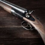 Close-up of a vintage shotgun with a wooden stock and metallic components