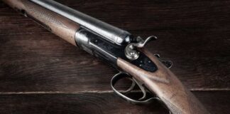 Close-up of a vintage shotgun with a wooden stock and metallic components