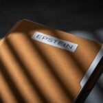 ARRESTED: Secret Intelligence LEAKED to Epstein! A brown folder with the name 'EPSTEIN' on it, partially illuminated by light and casting shadows