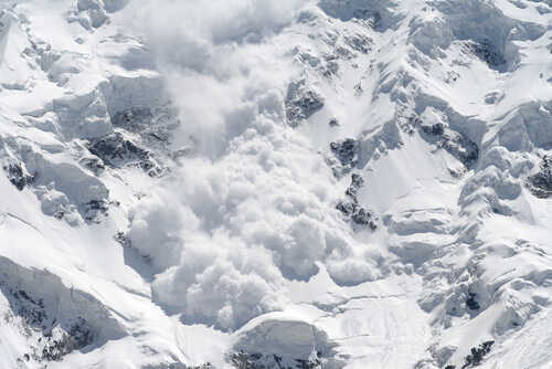 An avalanche cascading down a snowy mountain