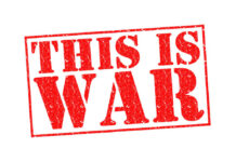 A bold red stamp with the text 'THIS IS WAR'