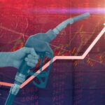 Hand holding a fuel nozzle with rising graph lines in the background