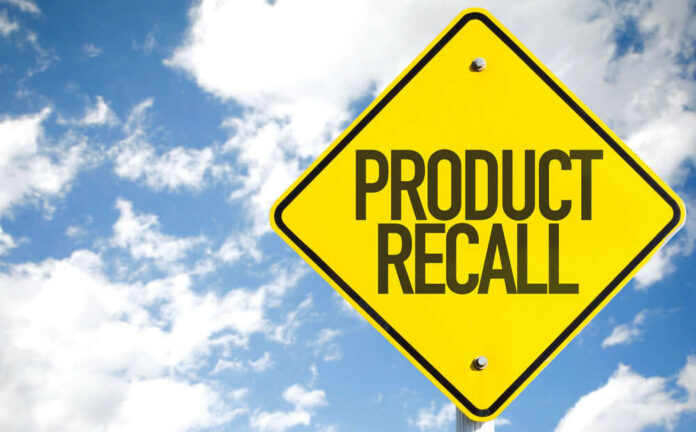 shutterstock_419918254.jpg Yellow product recall sign against cloudy sky