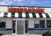 Exterior view of a Steak 'n Shake restaurant with a striped awning