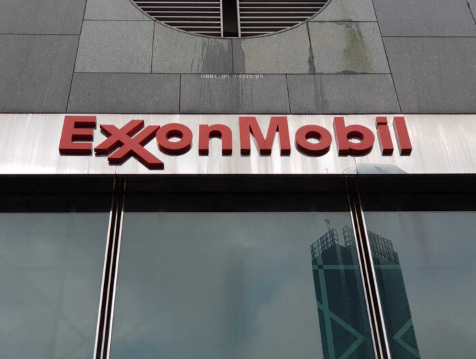shutterstock_1219891207.jpg ExxonMobil logo displayed on a glass building