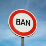 Sign reading BAN against blue sky background