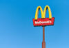 McDonald's restaurant sign against a clear blue sky