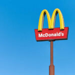 McDonald's restaurant sign against a clear blue sky