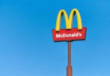 McDonald's restaurant sign against a clear blue sky