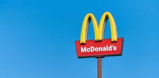 McDonald's restaurant sign against a clear blue sky
