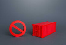 Chokepoint Shutdown Triggers Global Aid Panic A red prohibition sign next to a red shipping container