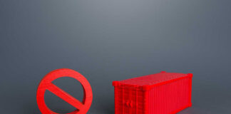 A red prohibition sign next to a red shipping container