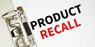 A binder clip holding a sheet of paper with the words 'PRODUCT RECALL' printed in bold letters