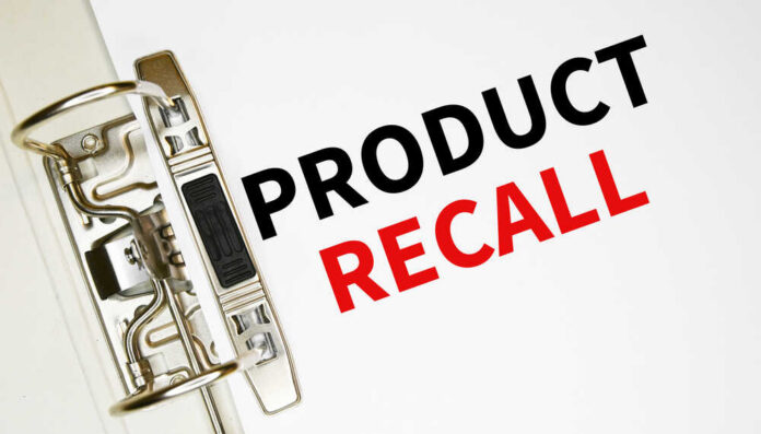 shutterstock_2003995796.jpg A binder clip holding a sheet of paper with the words 'PRODUCT RECALL' printed in bold letters
