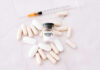 Fentanyl citrate vial surrounded by various pills and syringe.