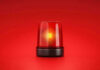 Red emergency light on solid red background.