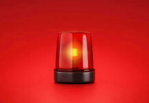Red emergency light on solid red background.