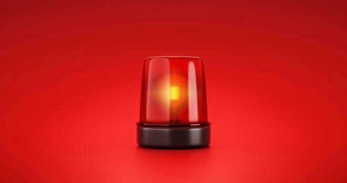 Red emergency light on solid red background.