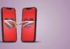 Two smartphones displaying hands reaching towards each other with heart backgrounds