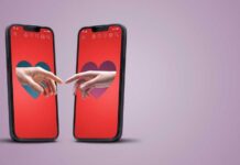 Two smartphones displaying hands reaching towards each other with heart backgrounds