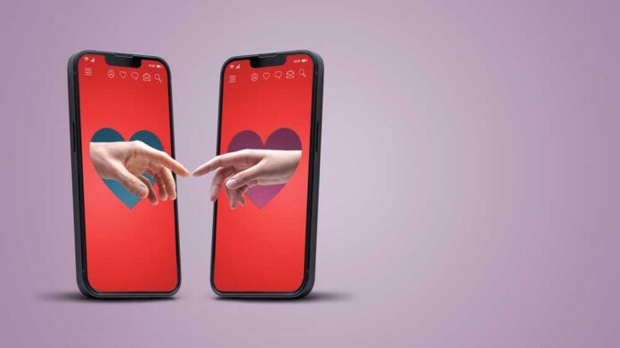 Two smartphones displaying hands reaching towards each other with heart backgrounds