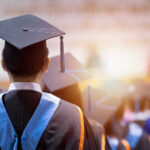 Graduates wearing caps and gowns in a ceremony.