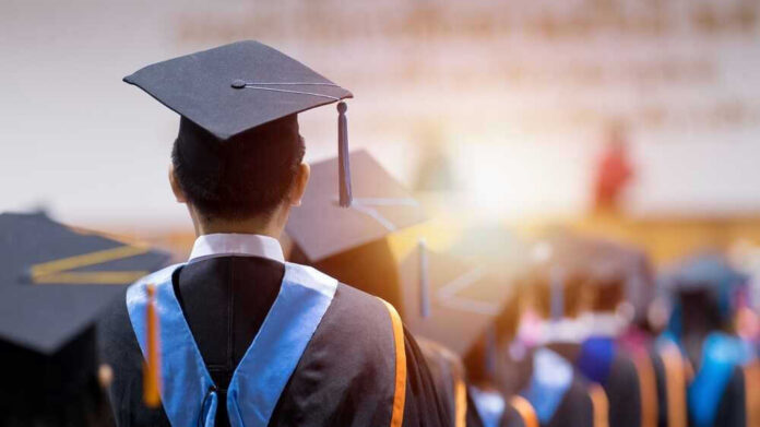 Graduates wearing caps and gowns in a ceremony.