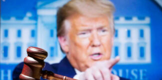 Gavel with Donald Trump speaking in the background.