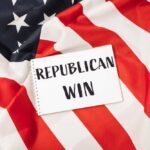 A notepad with the words 'REPUBLICAN WIN' on an American flag background