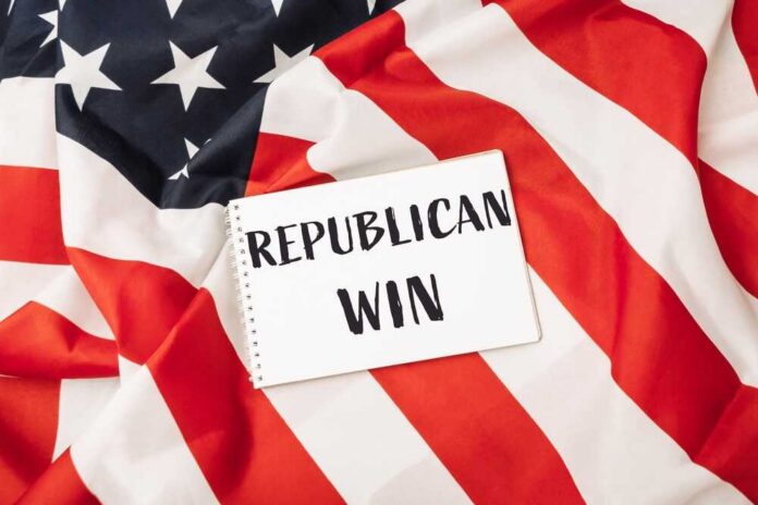 shutterstock_2535673055.jpg A notepad with the words 'REPUBLICAN WIN' on an American flag background